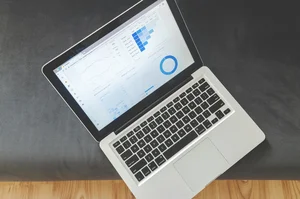 Modern business workspace with AI interfaces and analytics dashboards